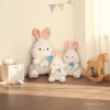 A big white rabbit plush toy, a sleeping doll on the bed, a cute baby bottle rabbit doll, a birthday gift for a girl details Picture